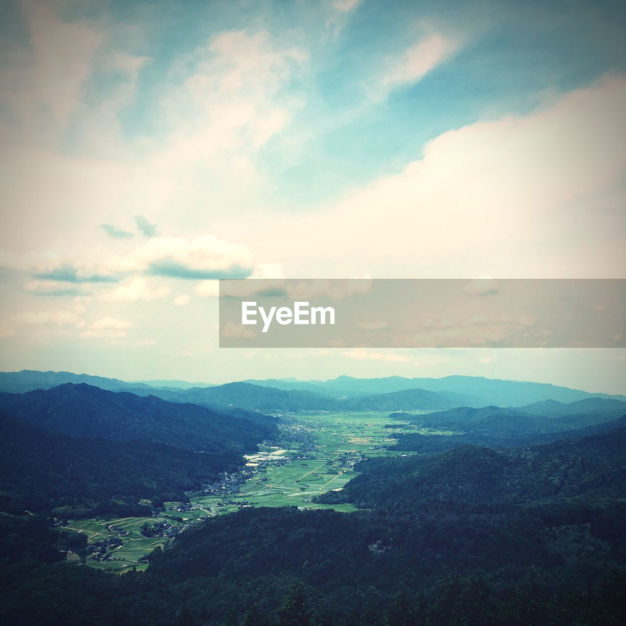 SCENIC VIEW OF MOUNTAINS AGAINST CLOUDY SKY