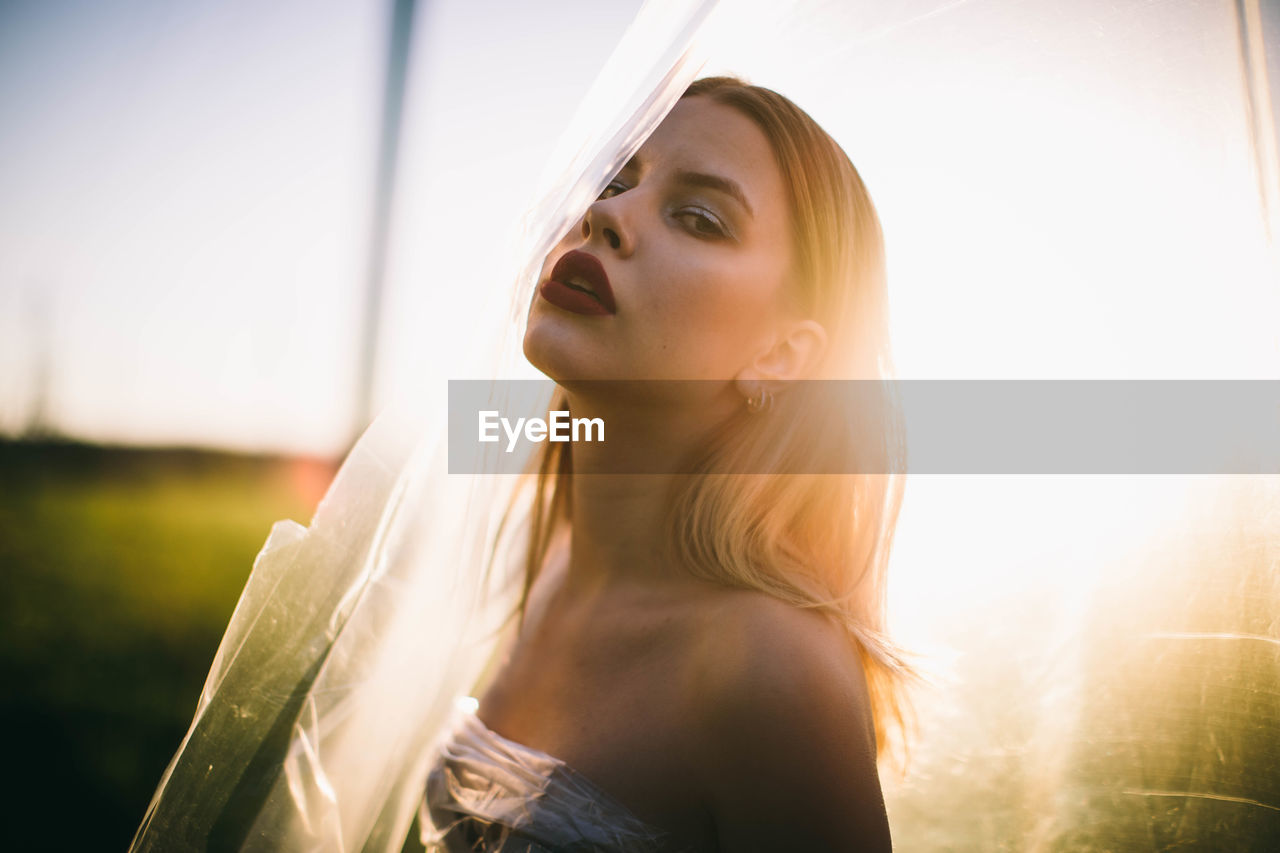 Portrait of young woman with plastic