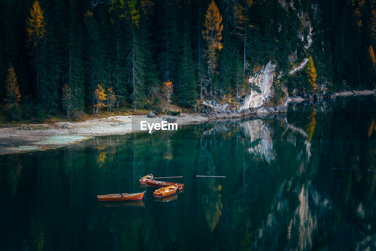 Boats in lake against mountains