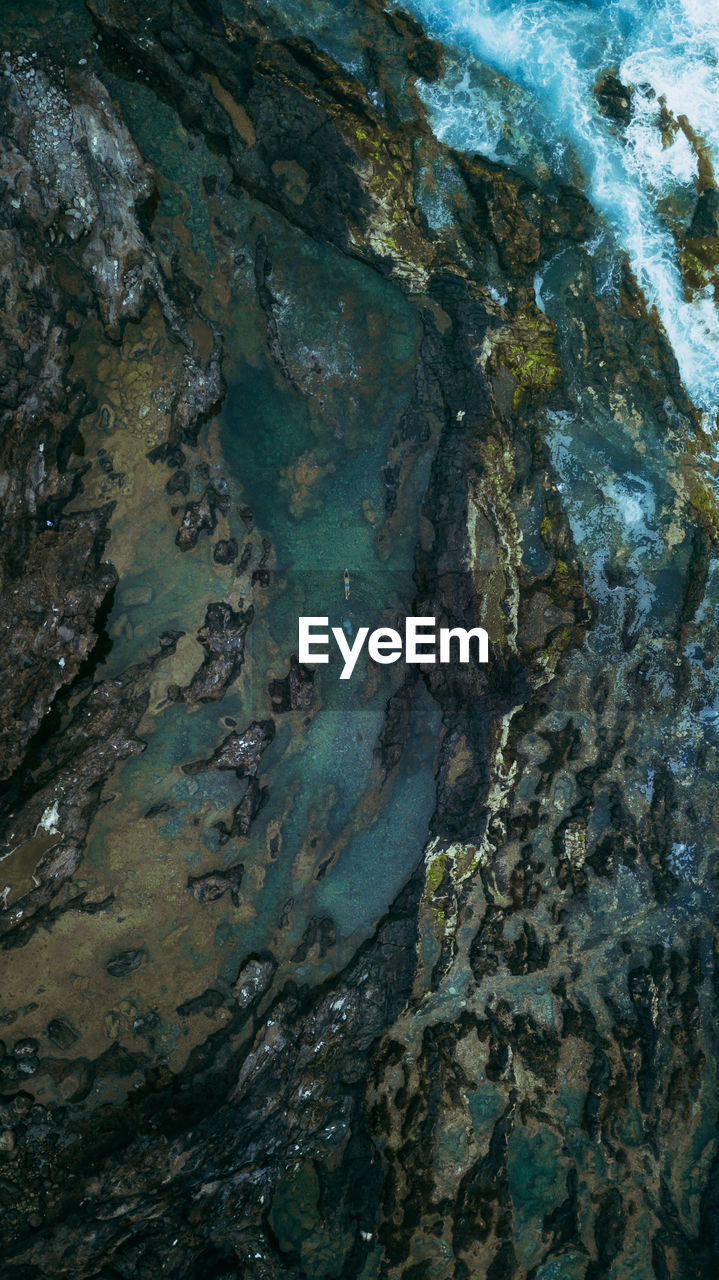 Aerial view of rock formation at beach