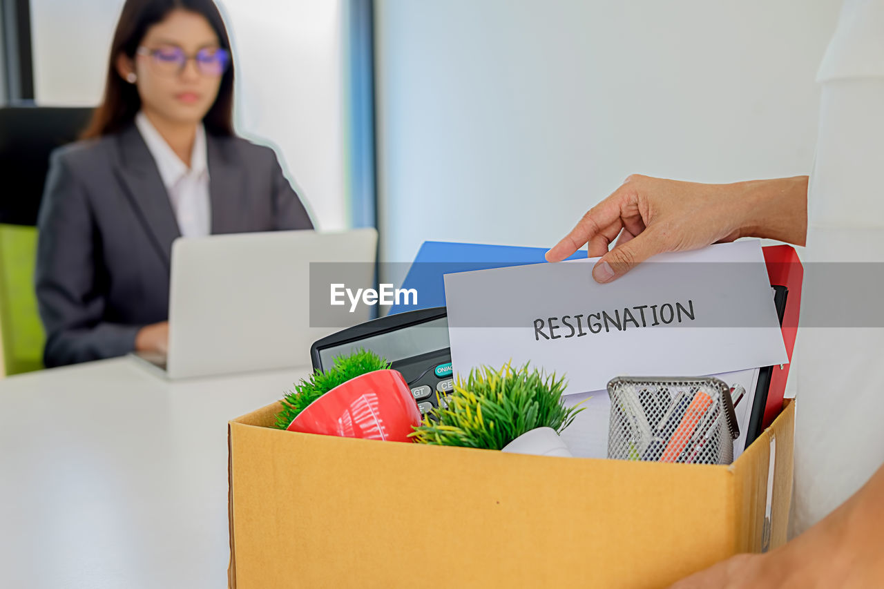 Colleagues with objects at desk in office