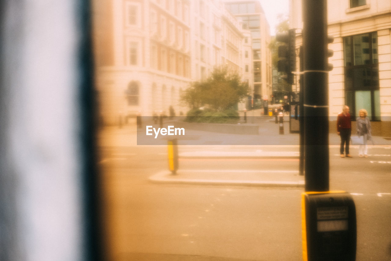 BLURRED MOTION OF CAR ON STREET BY BUILDINGS