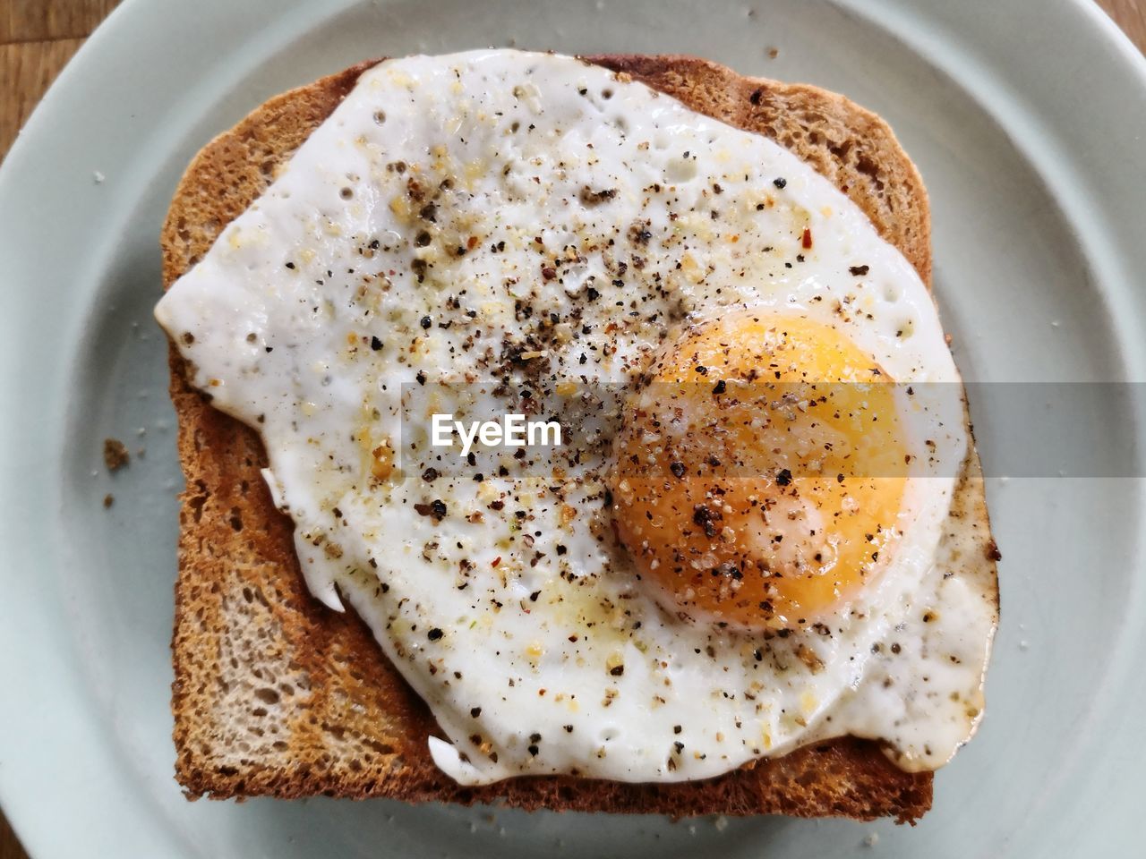 High angle view of bread with fried egg on plate