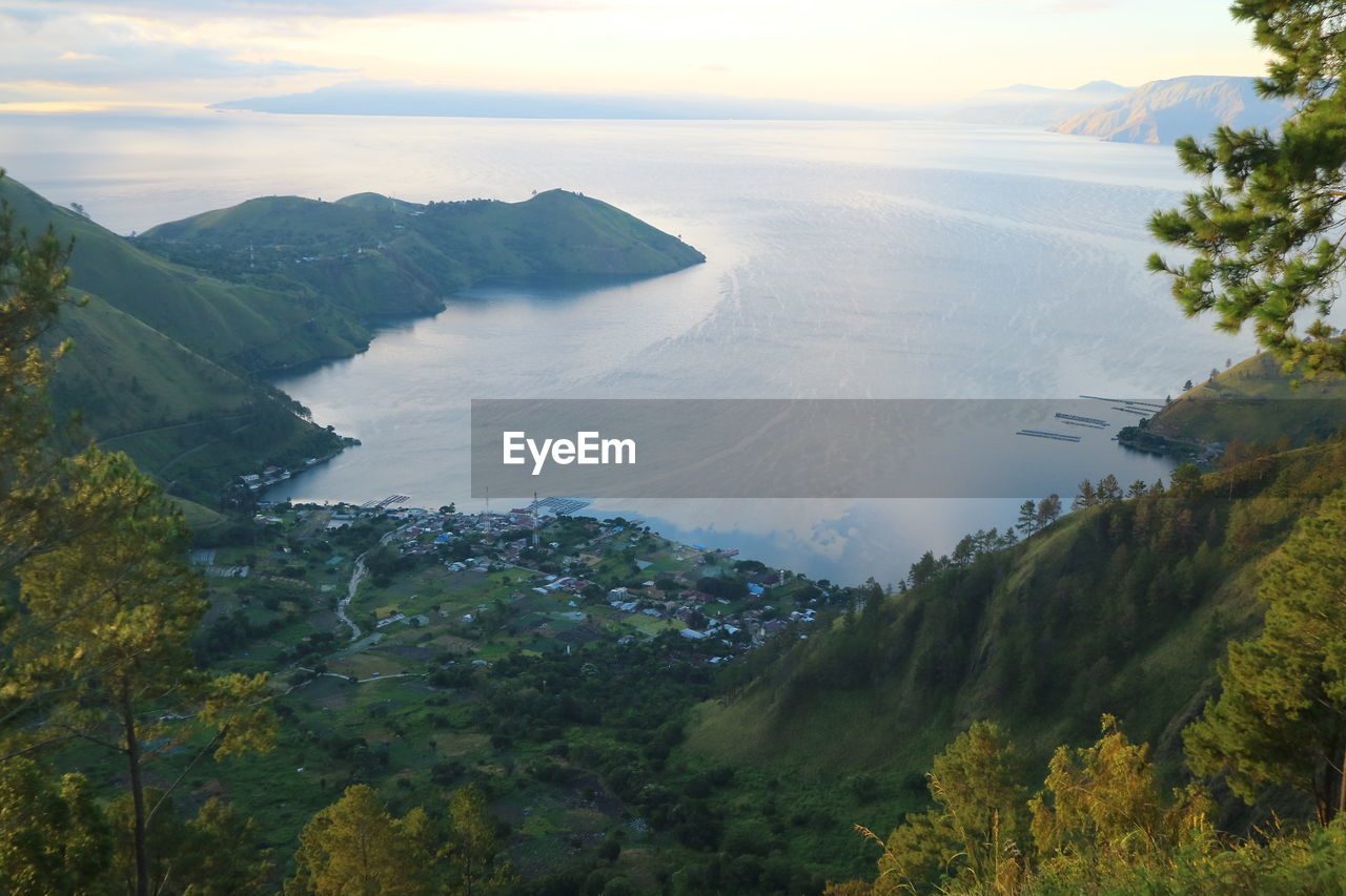 High angle view of sea and mountains against sky