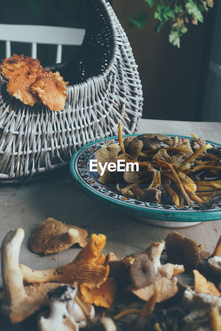 Basket with edible mushrooms  in  forest