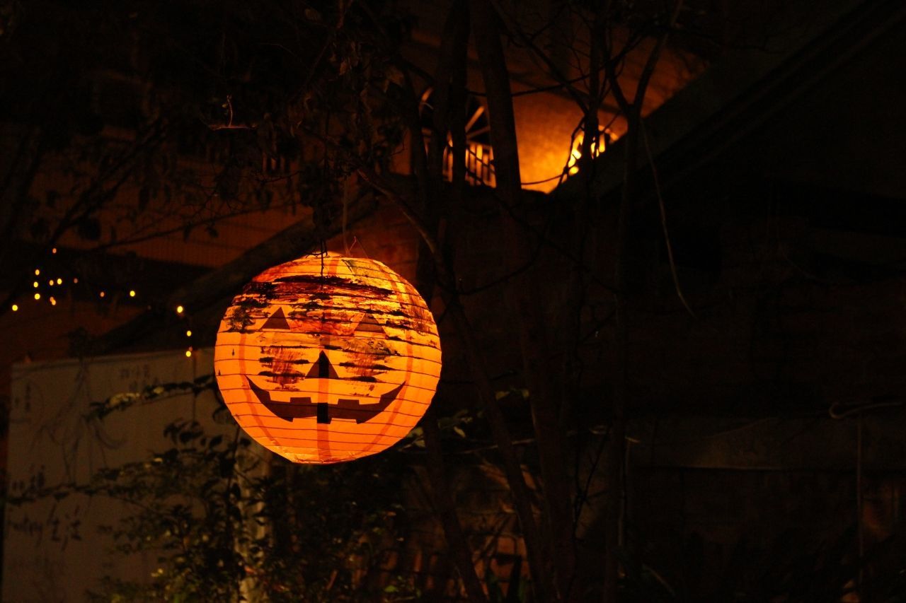 Halloween paper pumpkin lights hanging at night
