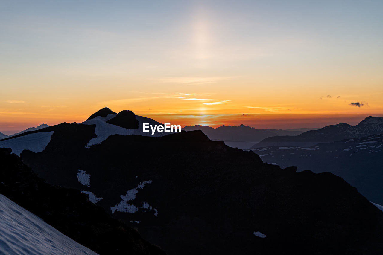 Scenic view of silhouette mountains against sky during sunset