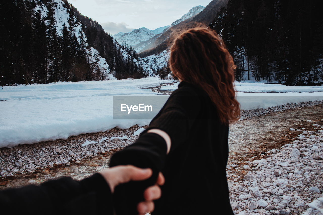 Woman looking at valley during winter