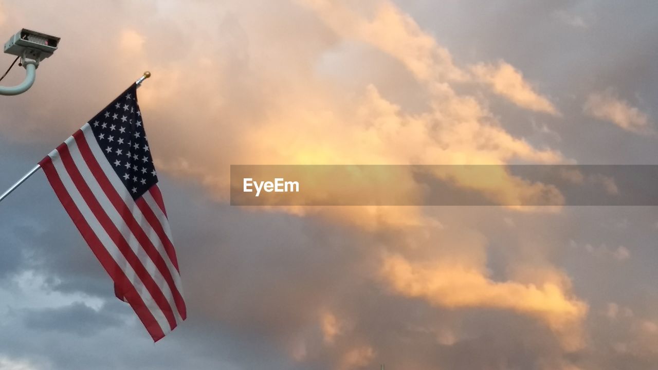 LOW ANGLE VIEW OF FLAGS AGAINST SKY