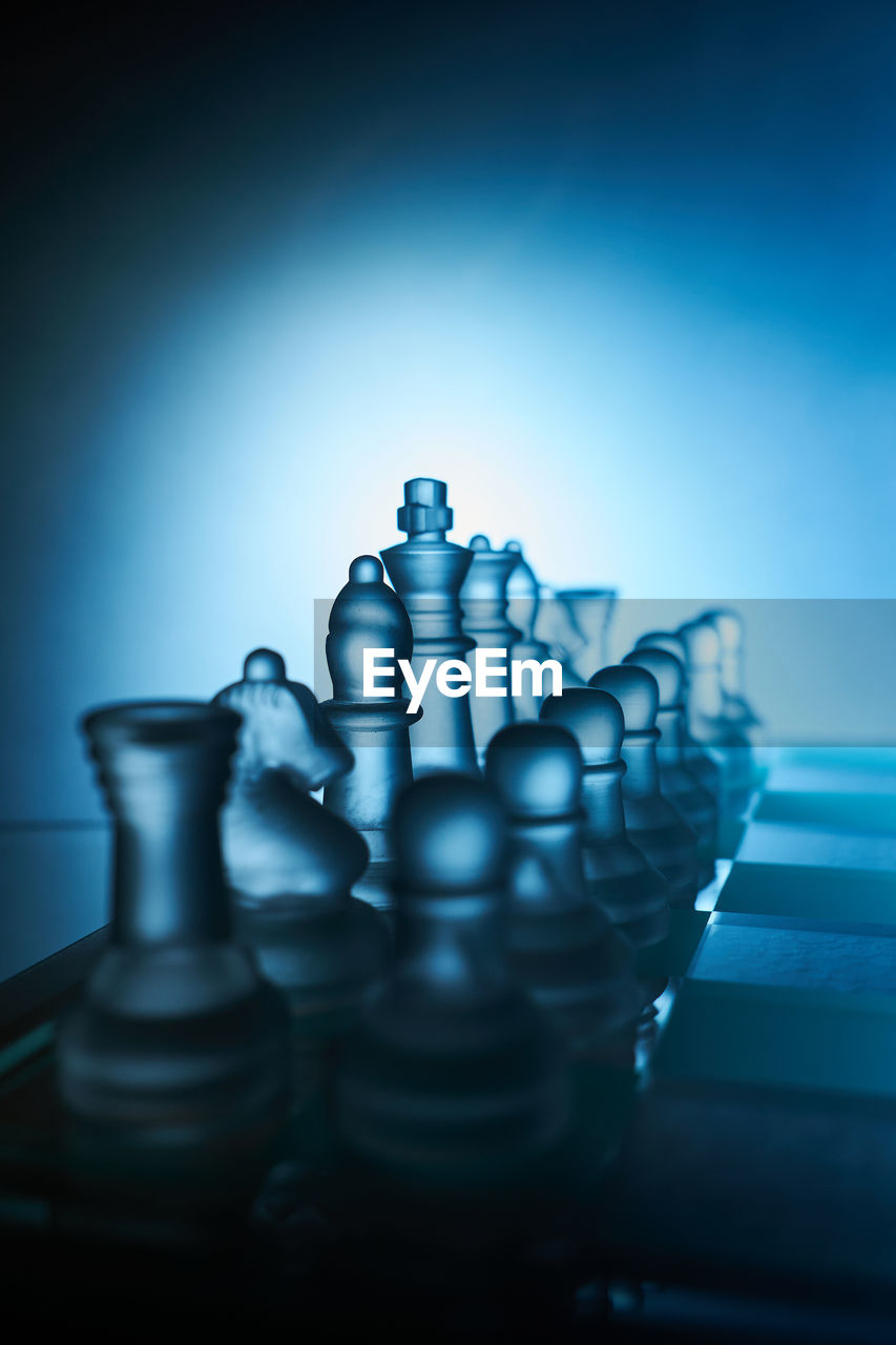 close-up of chess pieces against blue background