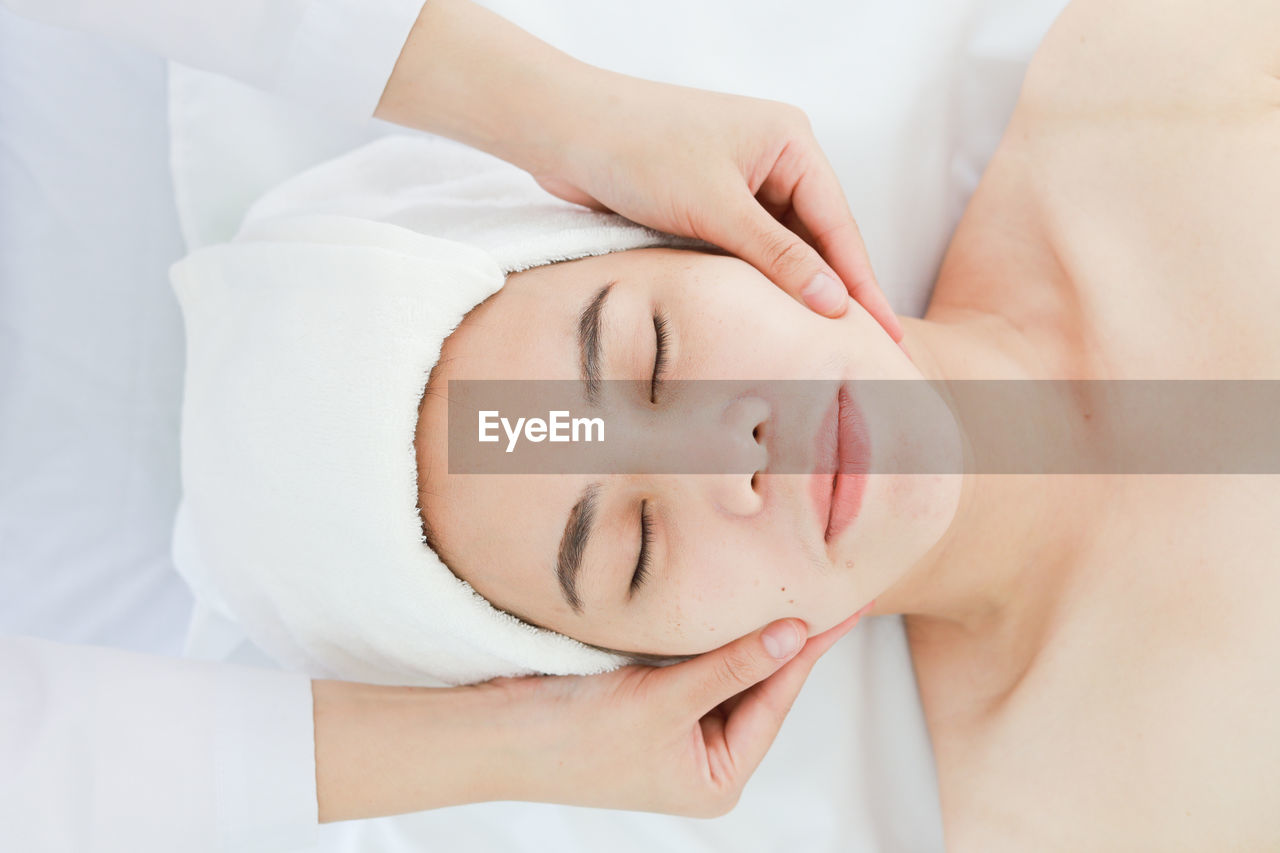 Midsection of woman massaging customer lying on table