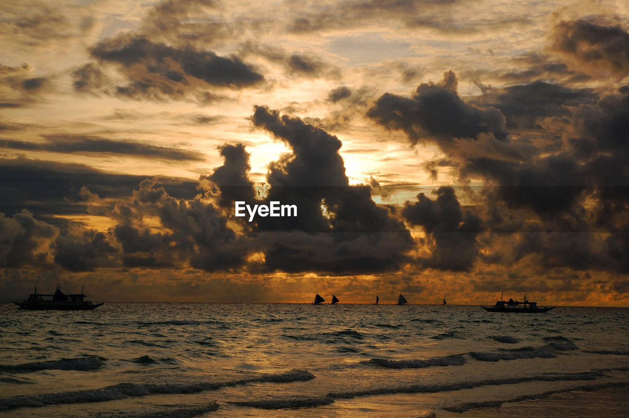 SCENIC VIEW OF BEACH AGAINST SKY DURING SUNSET