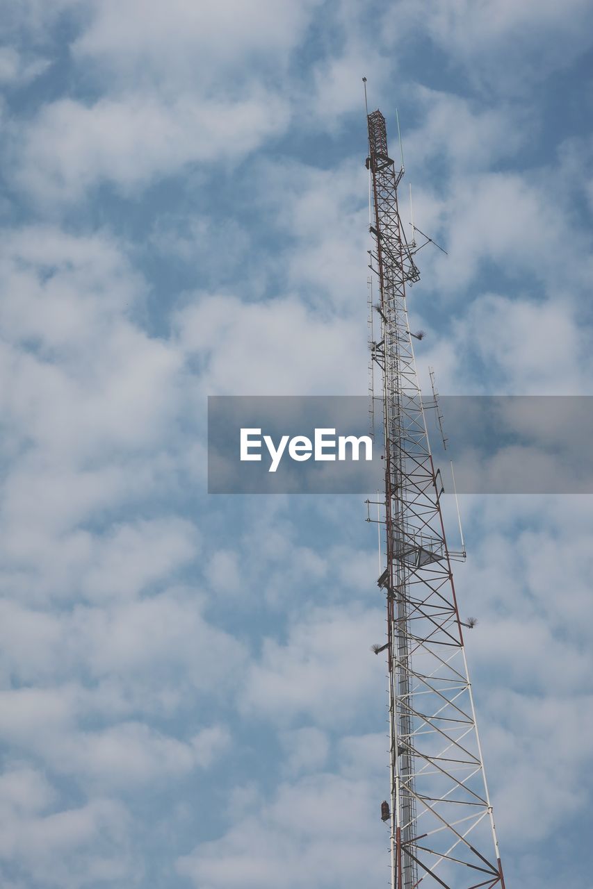 Low angle view of communications tower against sky