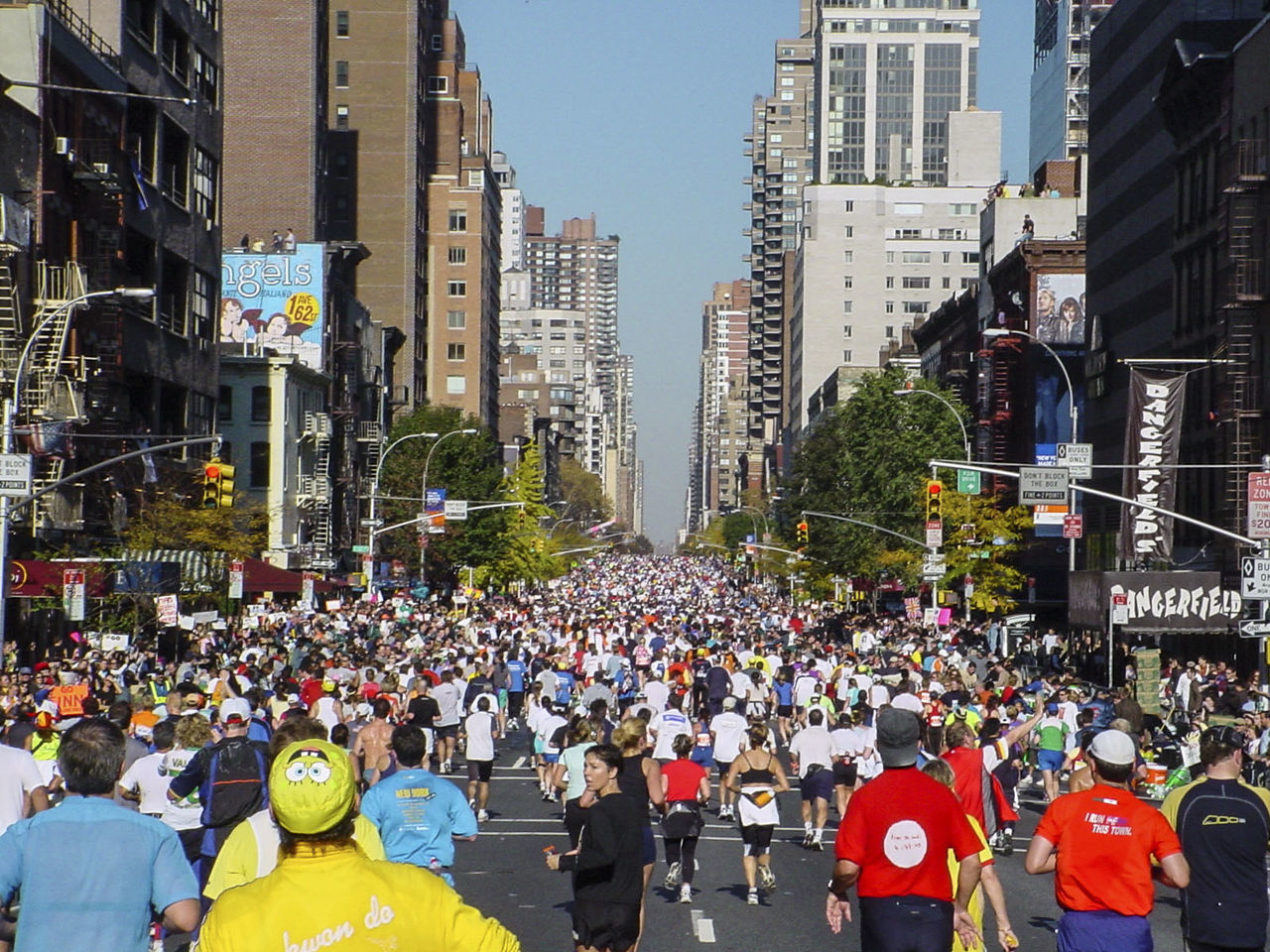 Crowd running on city street during marathon