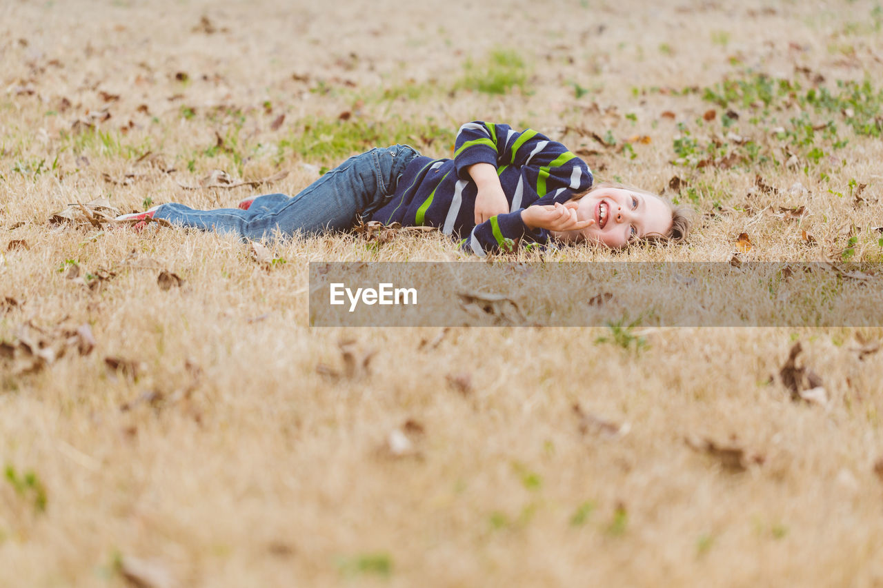 Smiling boy lying on grass