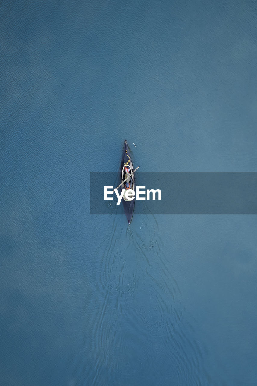 High angle view of person sailing on sea in canoe