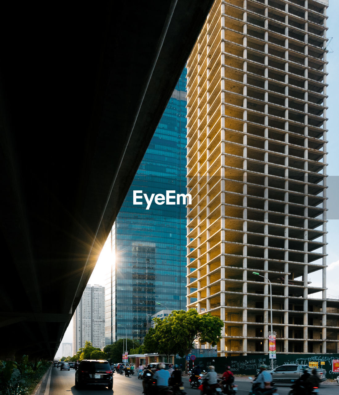 PEOPLE IN MODERN BUILDING AGAINST SKY