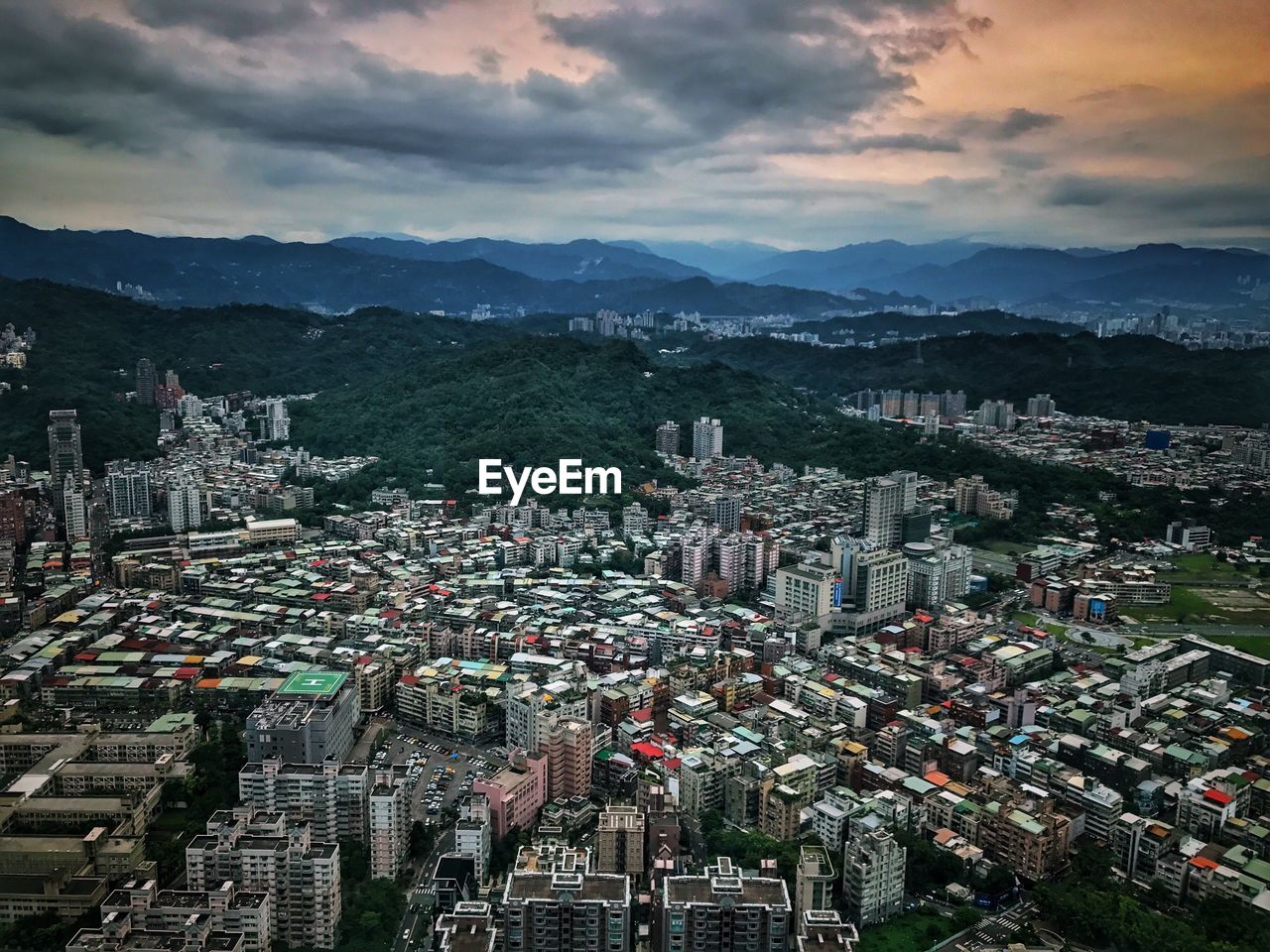 High angle view of cityscape against cloudy sky