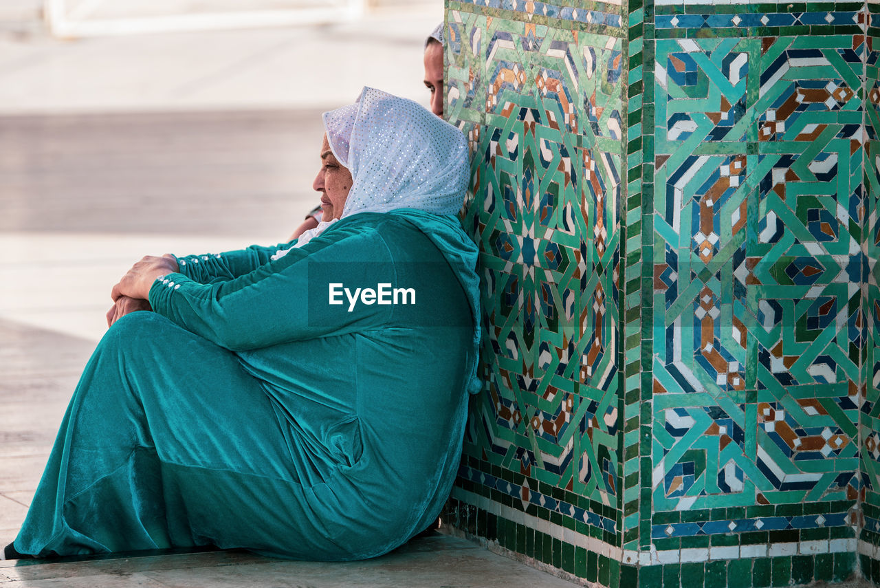 WOMAN SITTING ON FLOOR