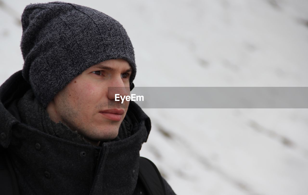 Man in warm clothing looking away outdoors