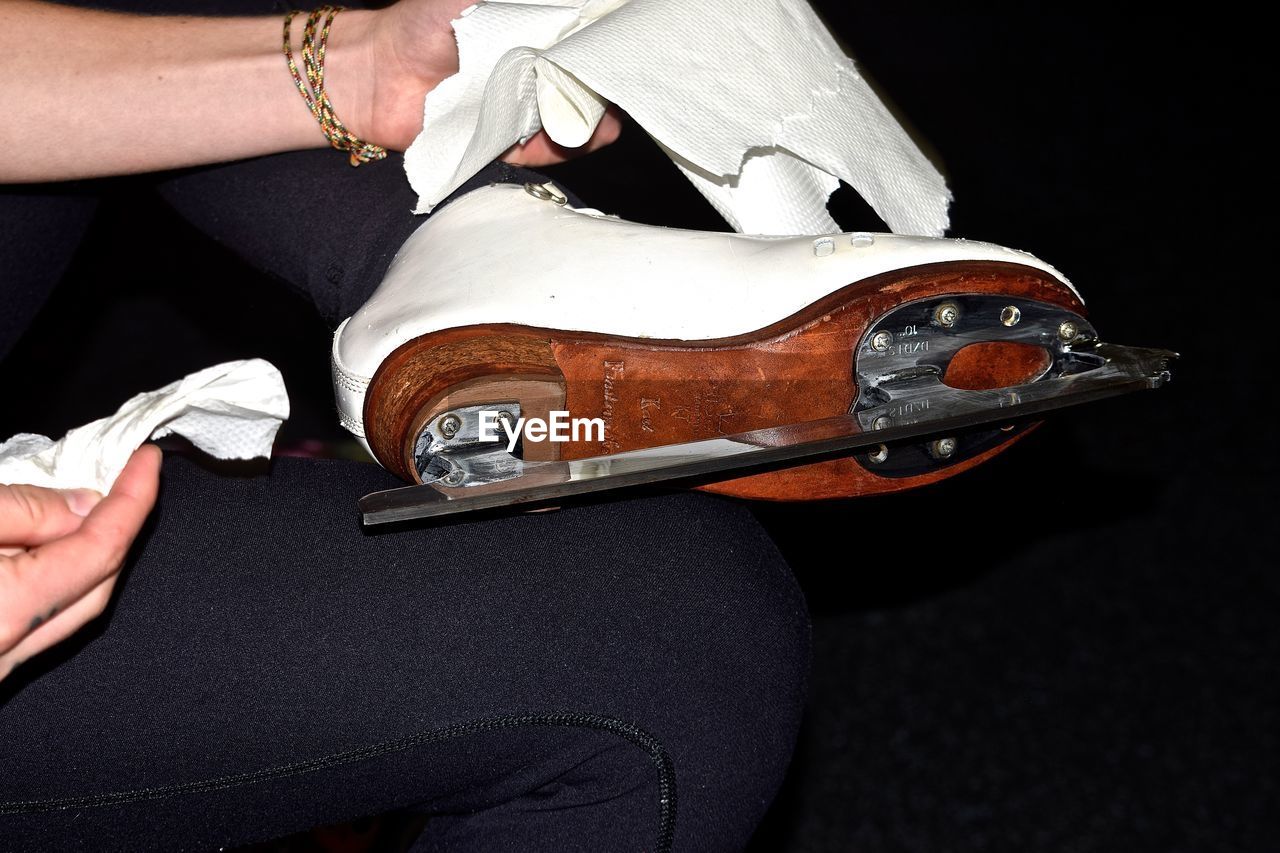 Cropped image of woman cleaning skate