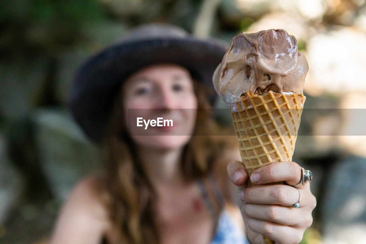 Portrait of woman holding ice cream cone