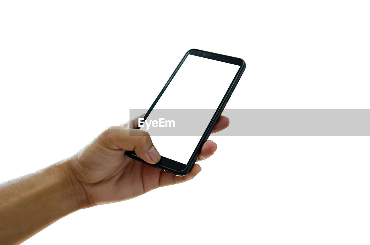 Cropped hand of person using smart phone against white background