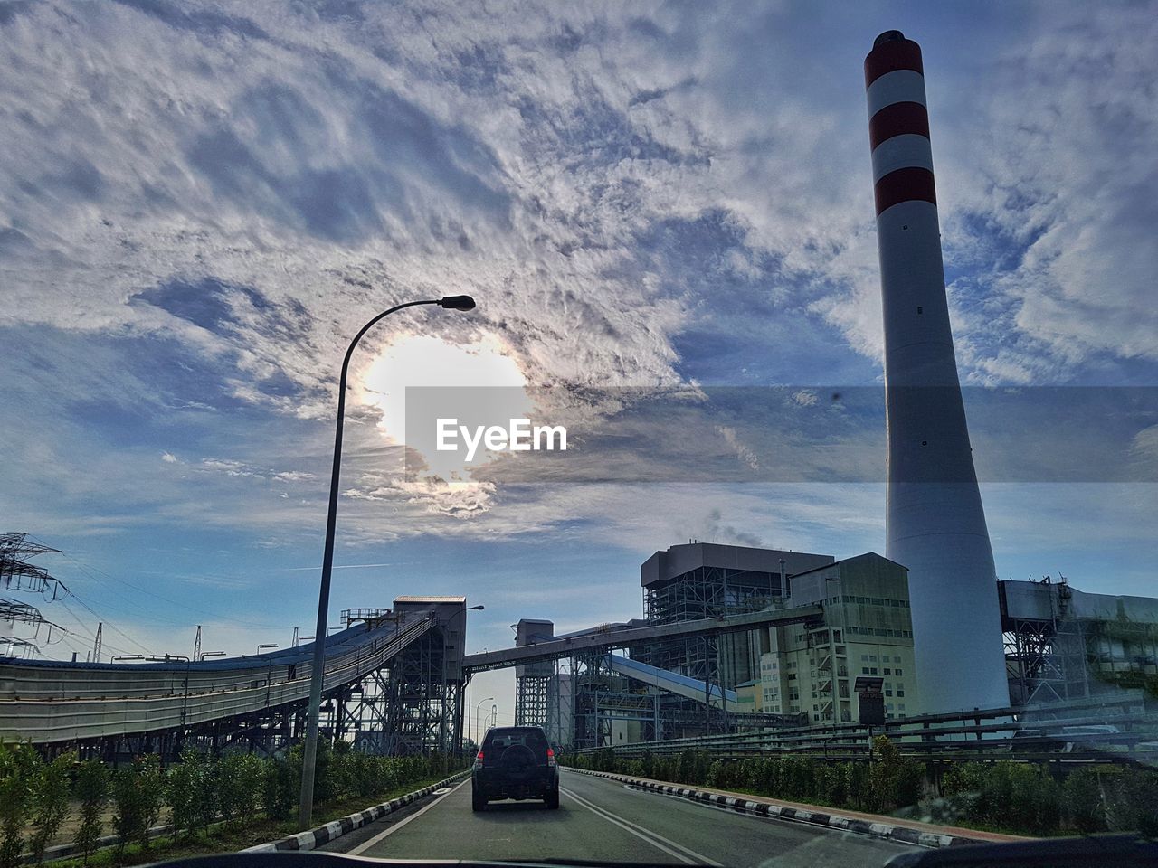 Low angle view of buildings against cloudy sky