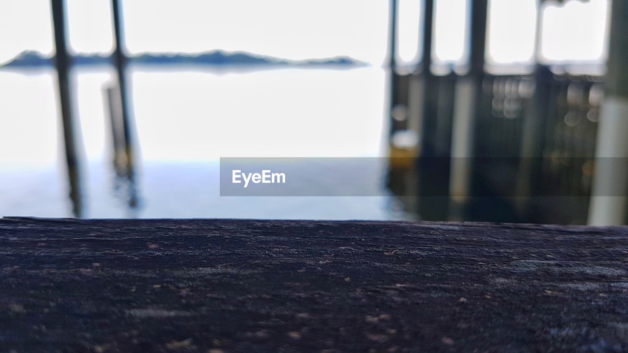 CLOSE-UP OF WATER ON TABLE AGAINST SKY