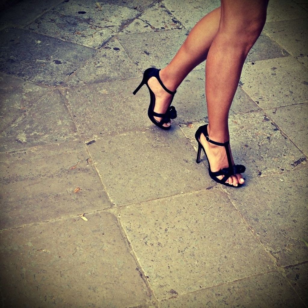 Low section of woman in high heels