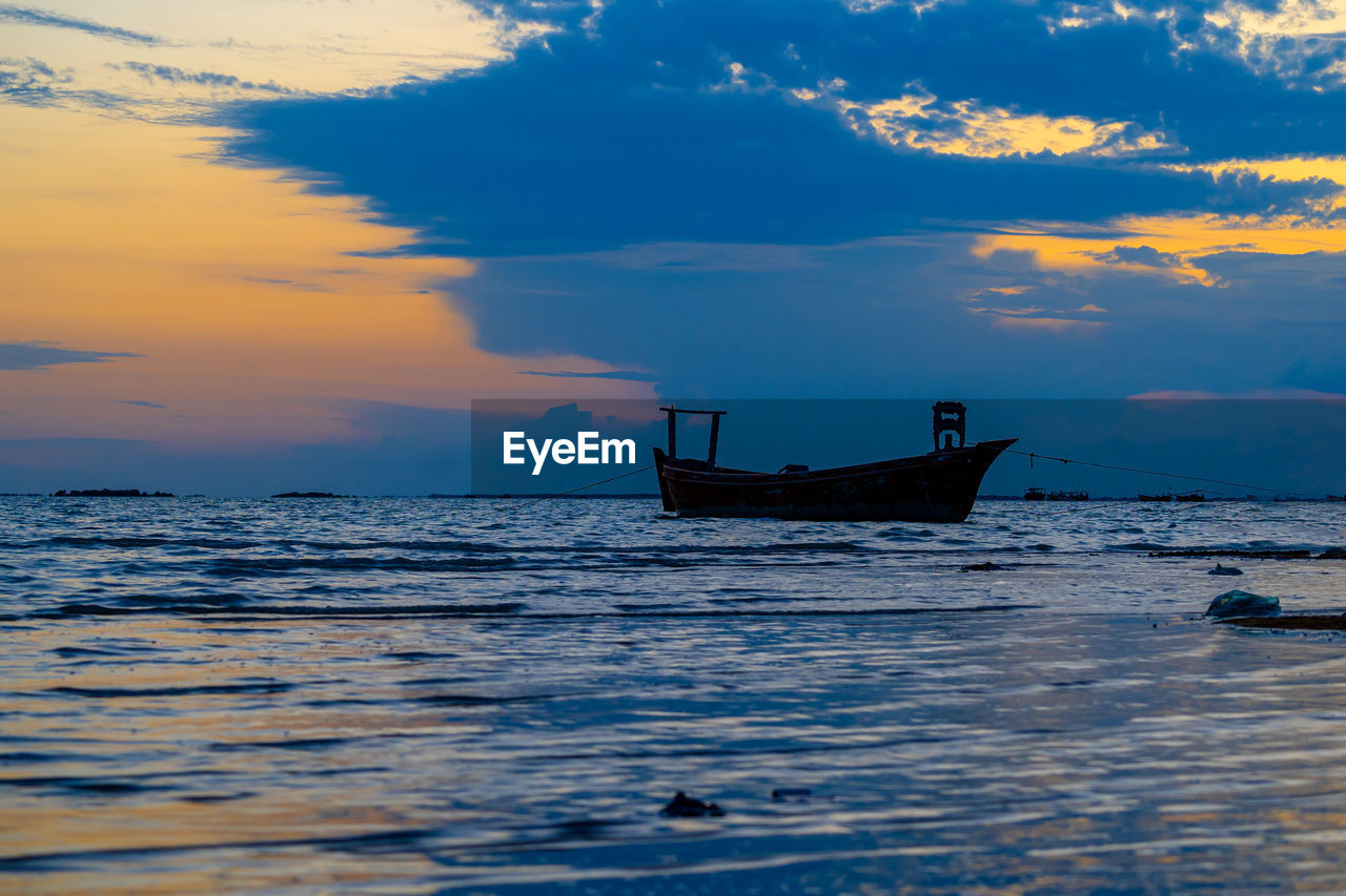Sunset view with cloudy sky at gadani beach with dhow boat