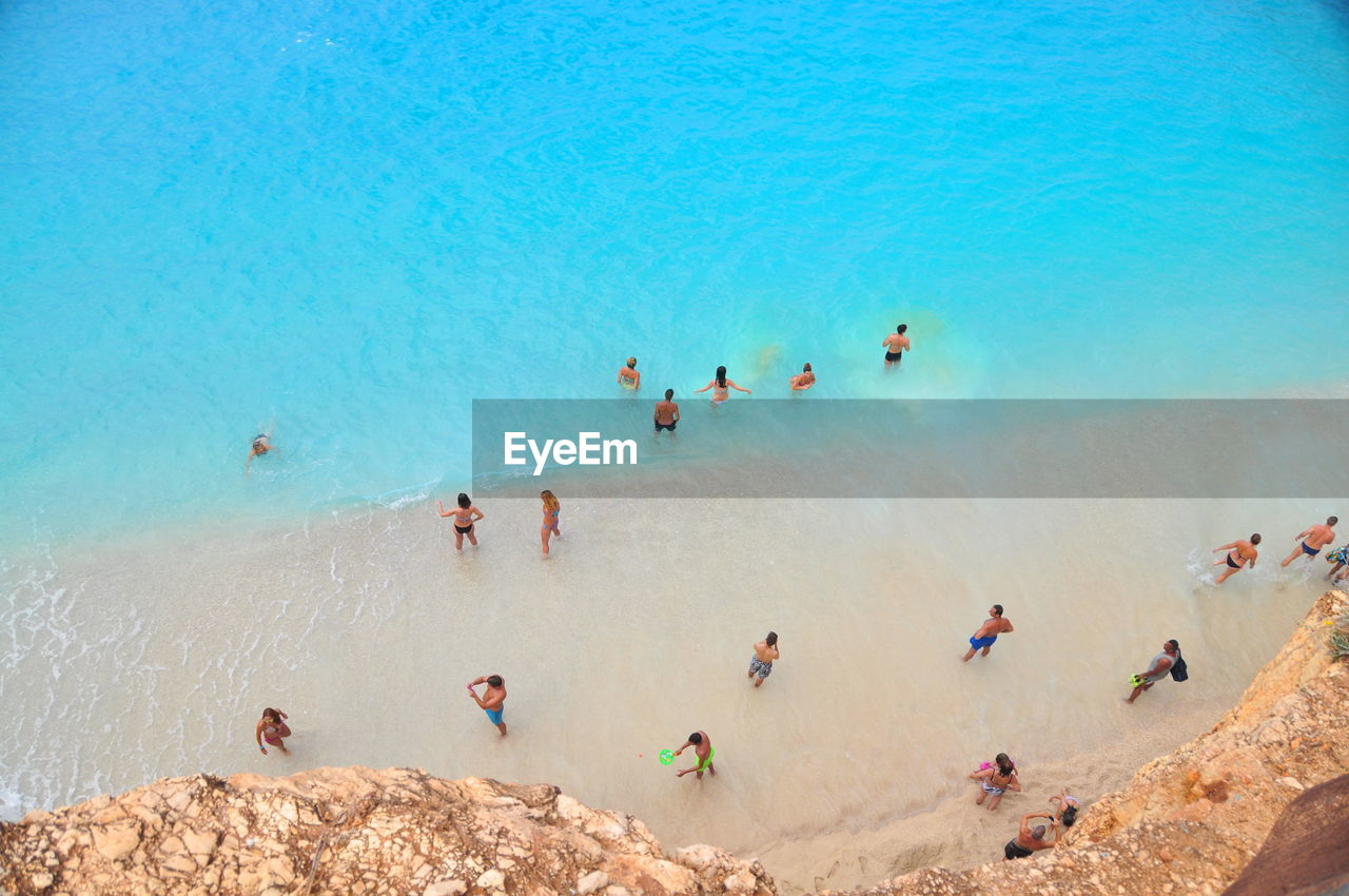 High angle view of people at beach against clear sky