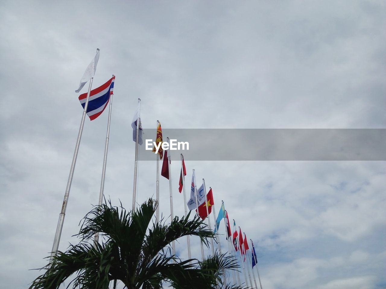 Low angle view of flags against sky