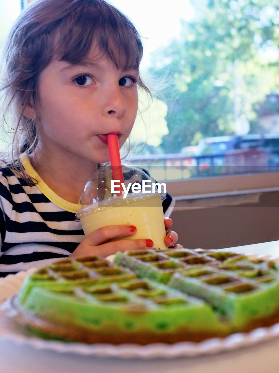 Portrait of girl drinking coffee at restaurant