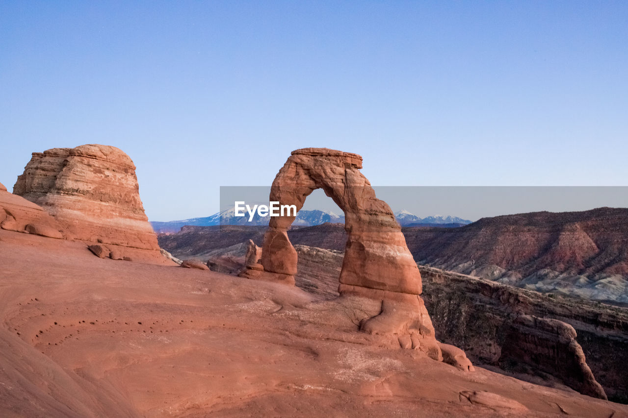 Rock formation in desert against clear sky