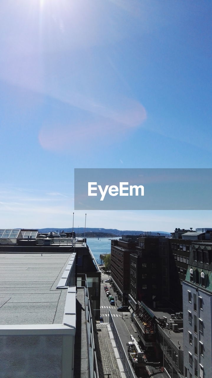 High angle view of buildings against blue sky