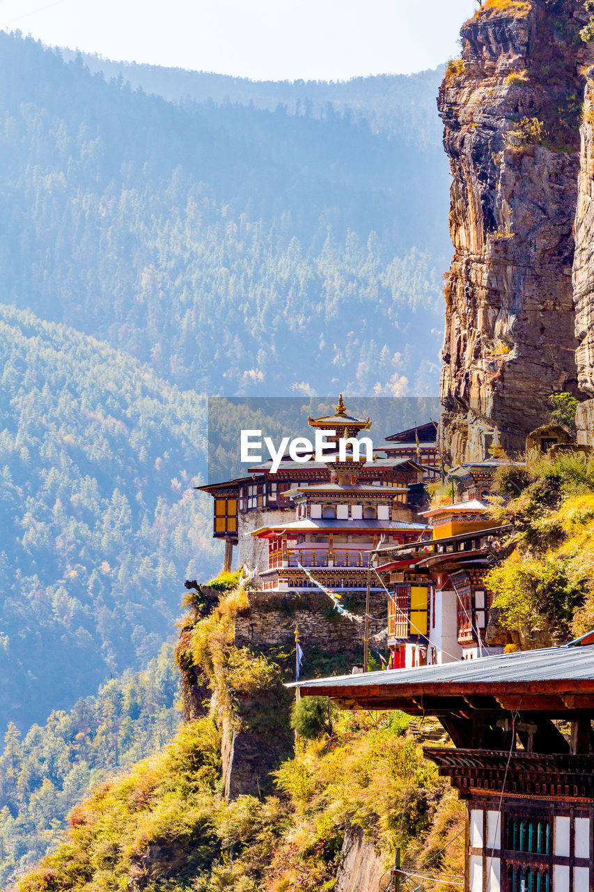 Buddhist temples on cliff against mountains