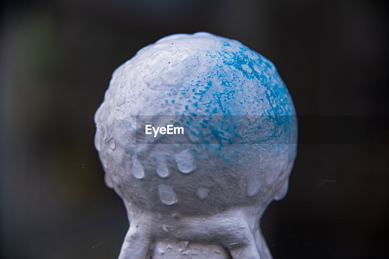 CLOSE-UP OF WATER DROPS ON BLUE SCULPTURE