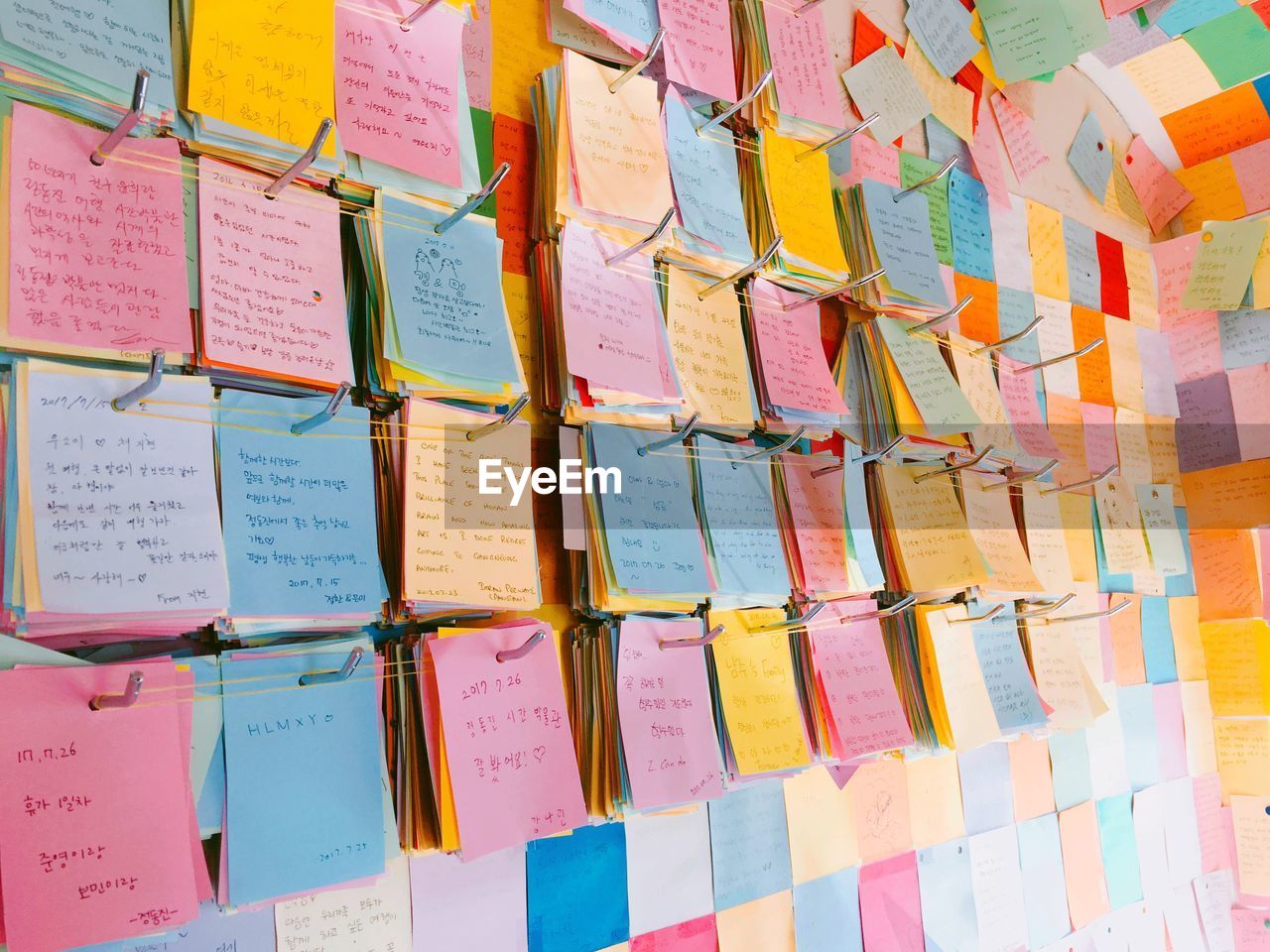 Colorful adhesive notes hanging on metal