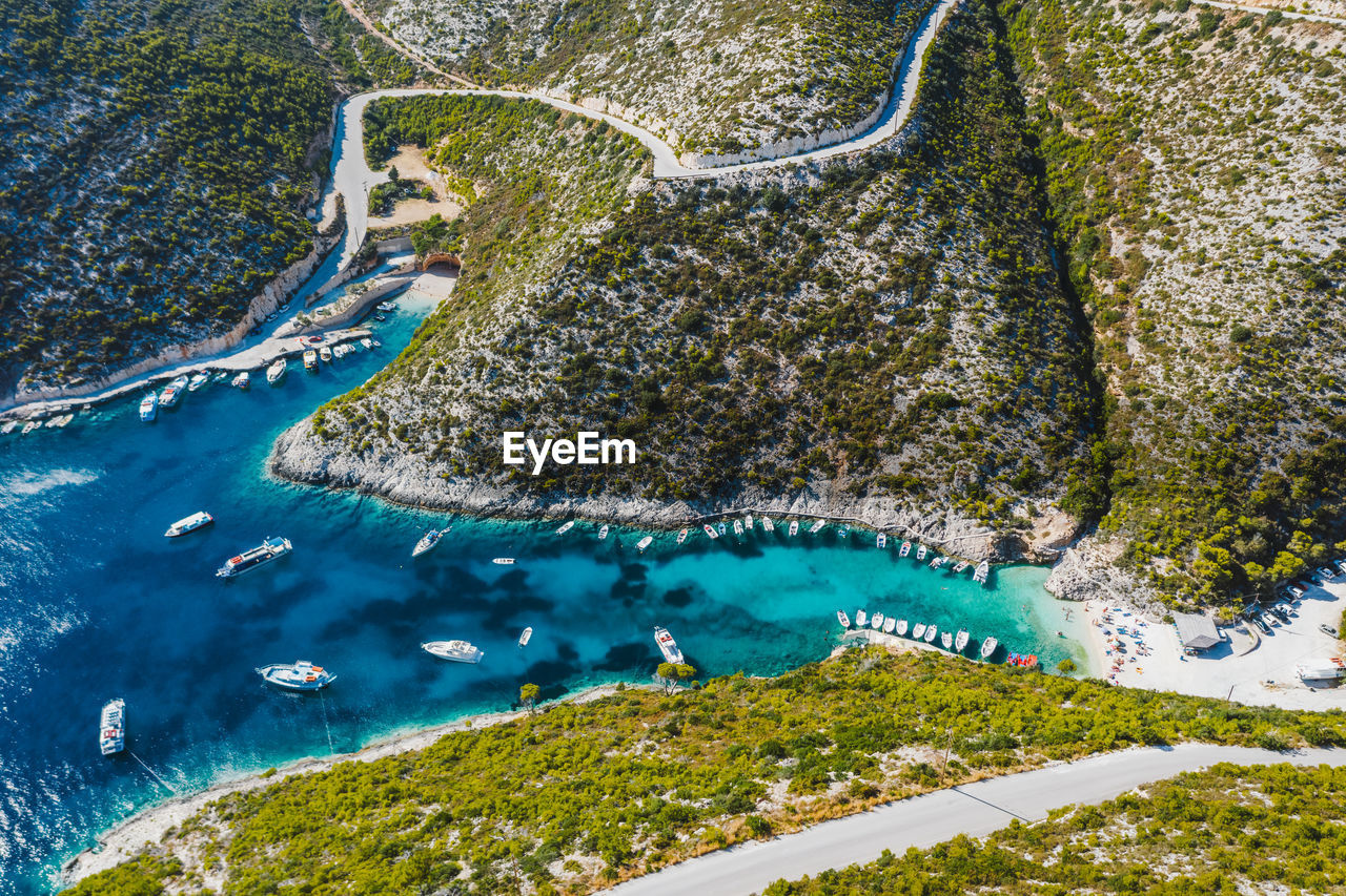 Aerial view of porto vromi with many fisher boats in the blue bay. zakynthos - zante island, greece