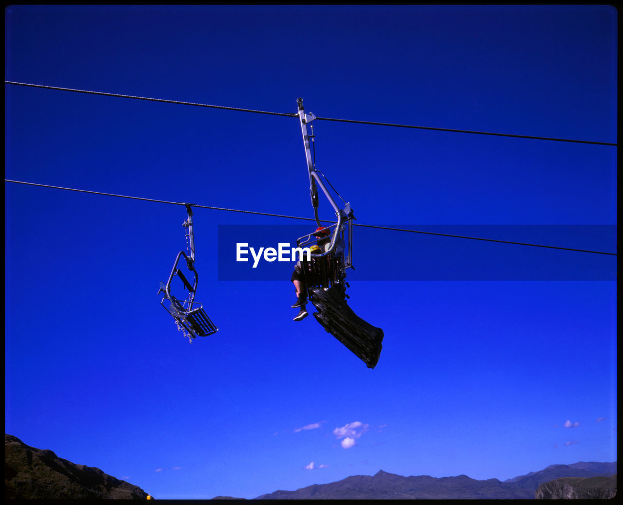 LOW ANGLE VIEW OF SKI LIFT AGAINST SKY