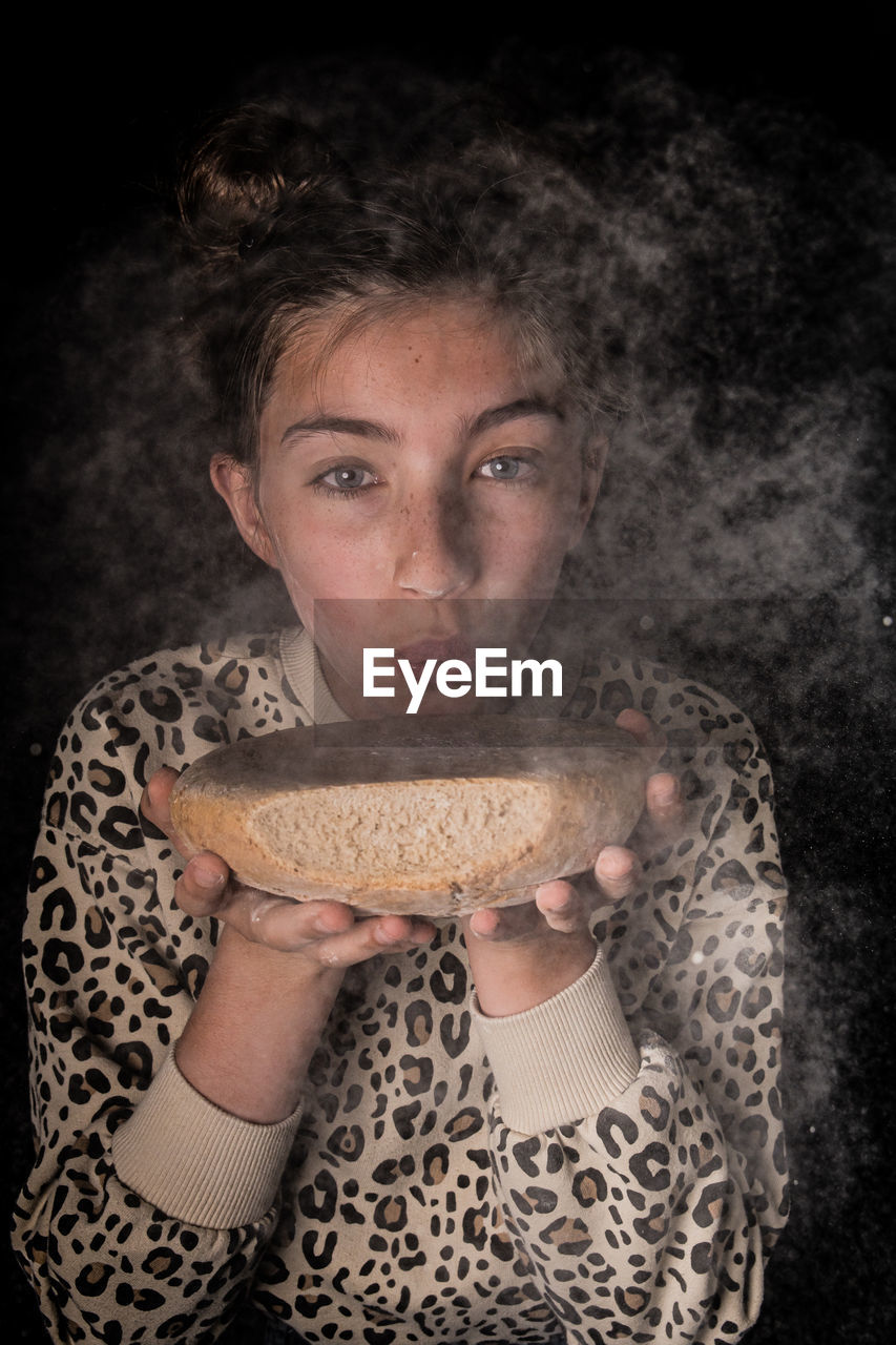 Portrait of a woman holding bread