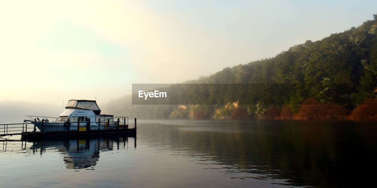 SCENIC VIEW OF LAKE WITH TREES IN BACKGROUND