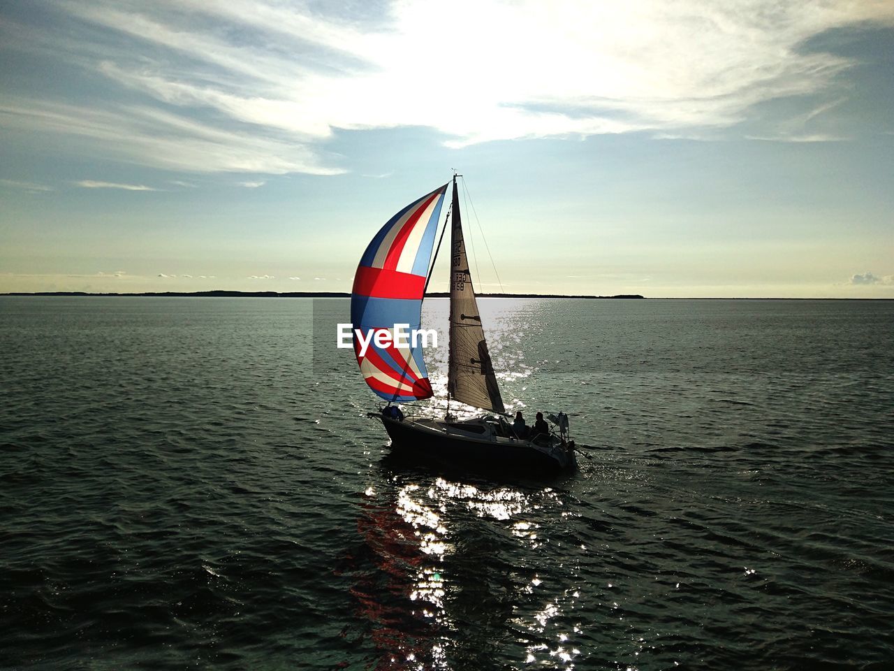 Sailboat on sea against sky