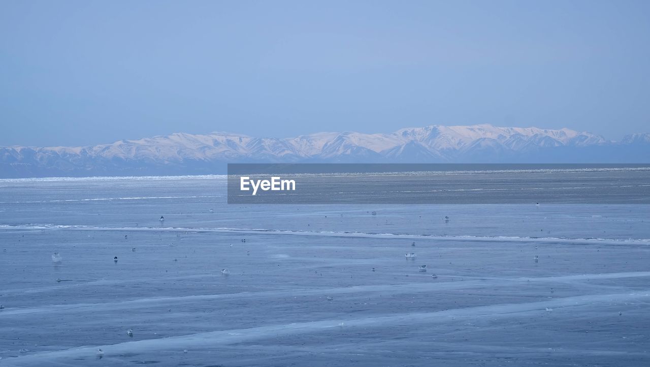 SCENIC VIEW OF SNOWCAPPED MOUNTAIN AGAINST SKY DURING WINTER