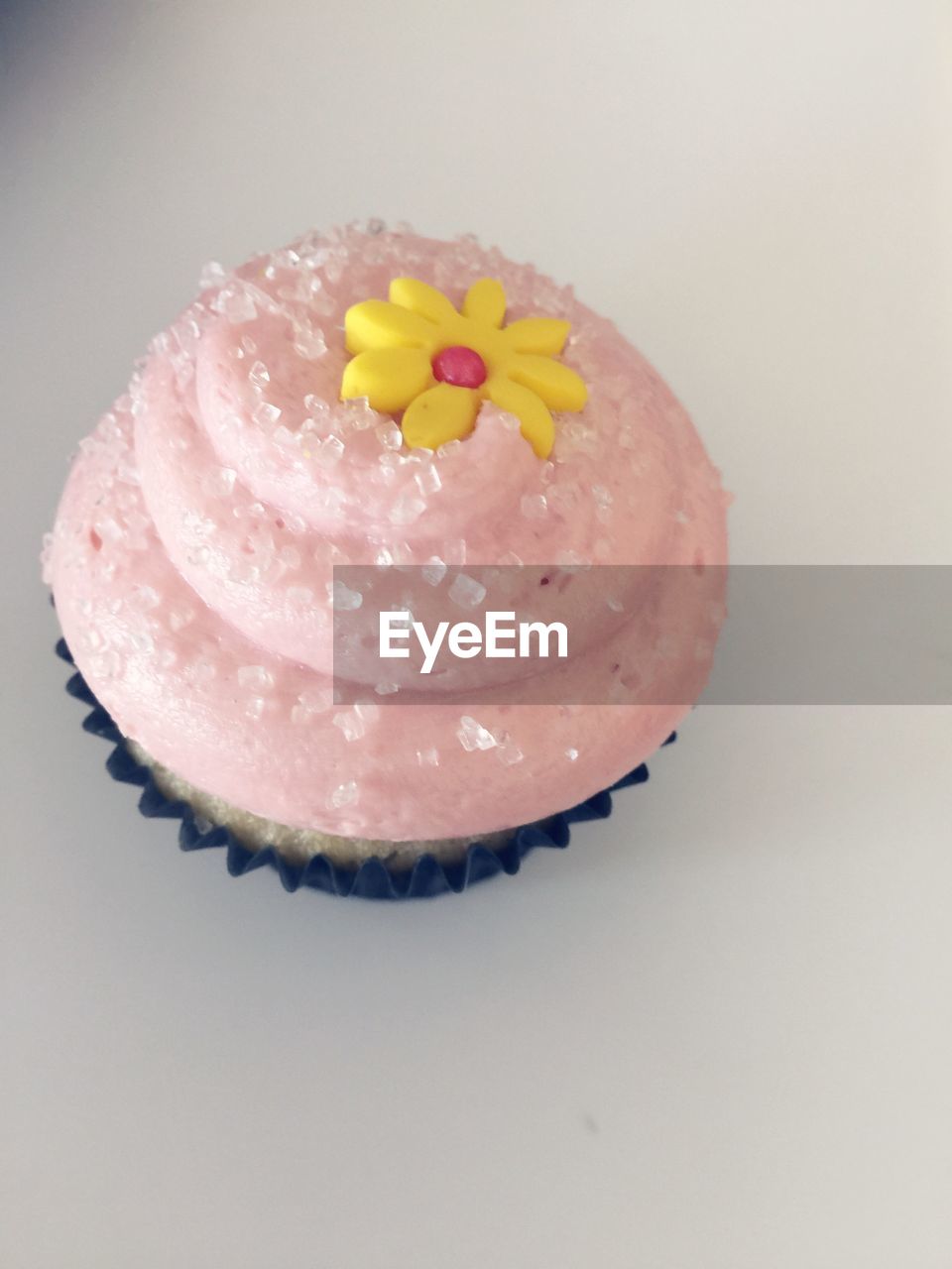 CLOSE-UP OF CUPCAKE ON WHITE BACKGROUND