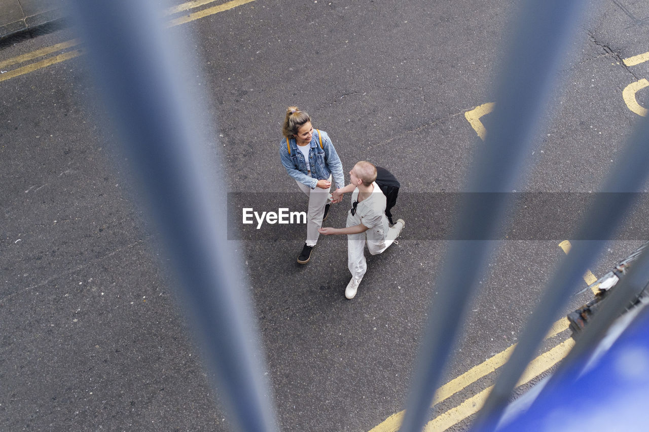 Lesbian couple walking together on urban street