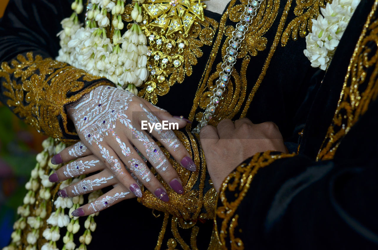 adult, one person, midsection, clothing, yellow, traditional clothing, wedding, event, bride, newlywed, hand, bracelet, jewelry, women, celebration, life events, tradition, wedding ceremony, arts culture and entertainment, bangle, henna, ceremony, close-up, lifestyles, holding, focus on foreground, gold, wedding dress