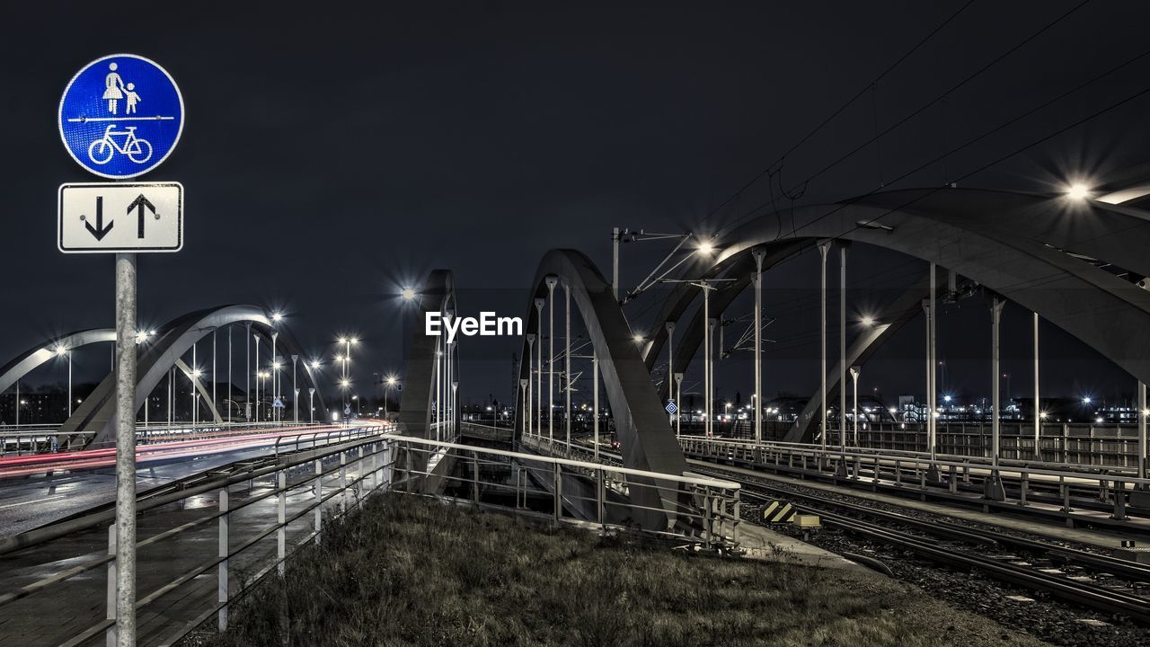 Illuminated bridge at night