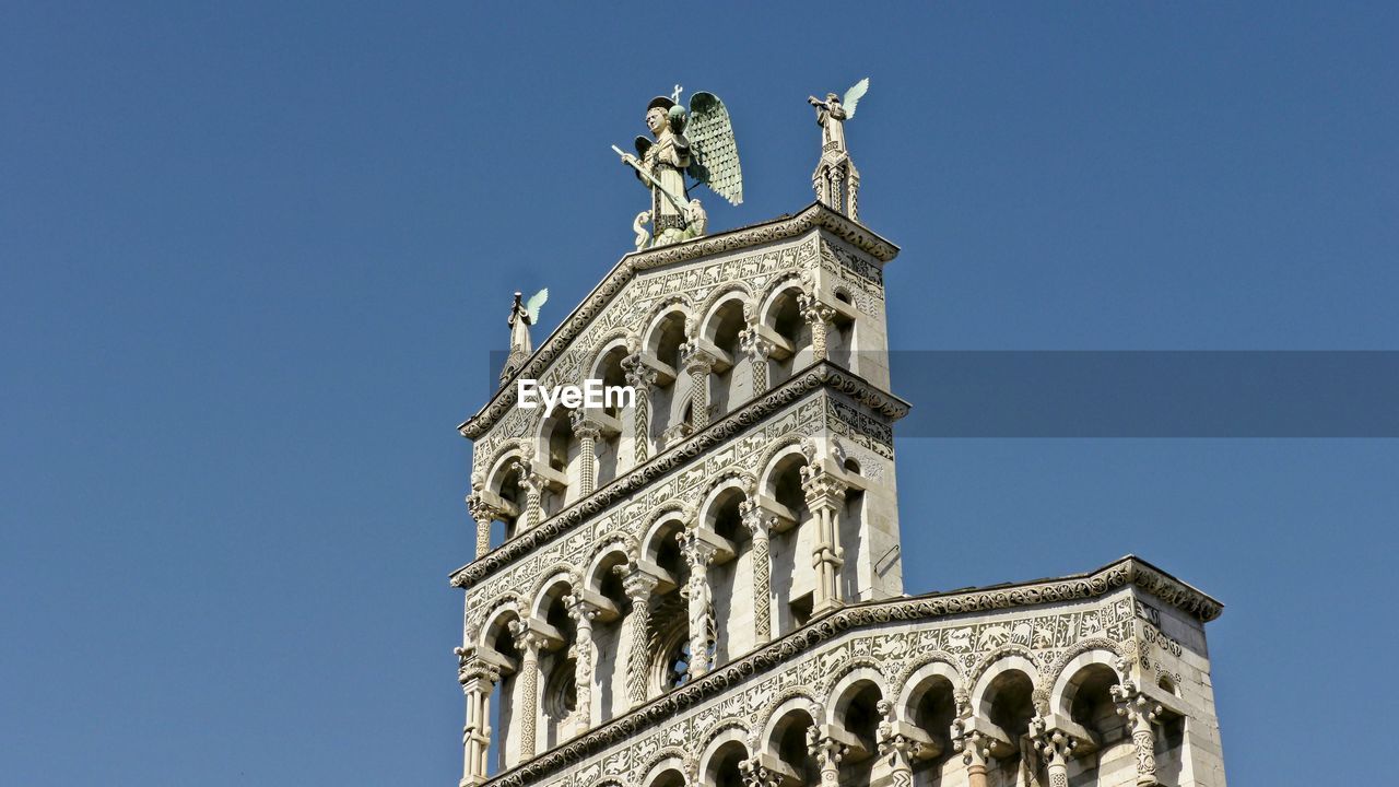 Low angle view of statue against blue sky